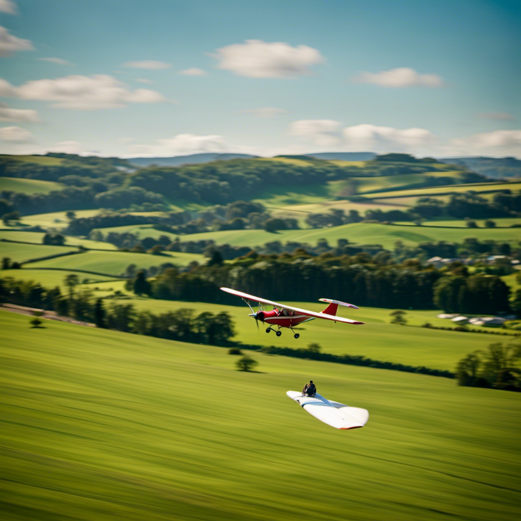 An image showcasing a vibrant glider soaring through the clear blue sky above lush green fields, surrounded by fellow enthusiasts at Bath Gliding Club