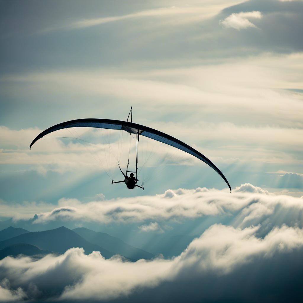 An image capturing the breathtaking sight of a hang glider soaring gracefully through the sky, suspended by its sturdy frame, sleek wings catching the wind, while the pilot effortlessly maneuvers amidst the clouds