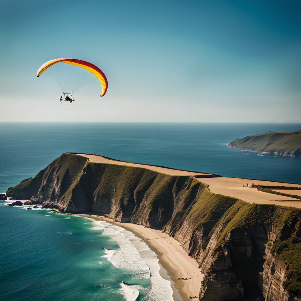 An image showcasing a pristine coastline framed by towering cliffs, where vibrant hang gliders soar through the clear blue sky
